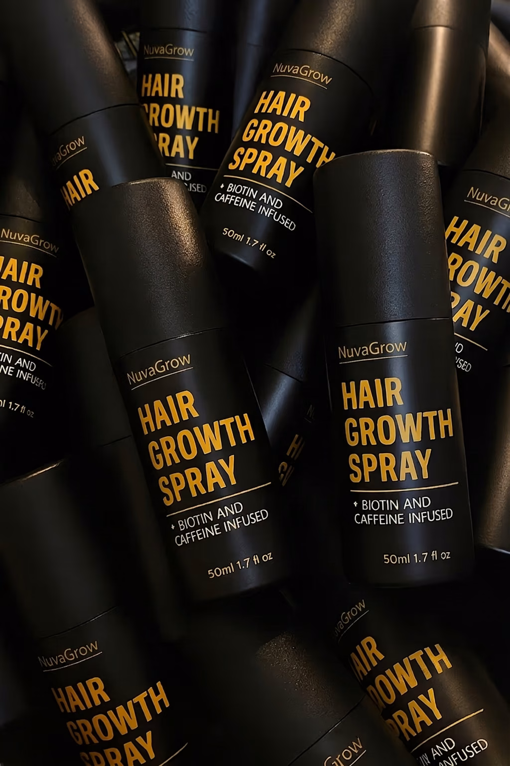 Several NuvaGrow scalp spray bottles stacked together
